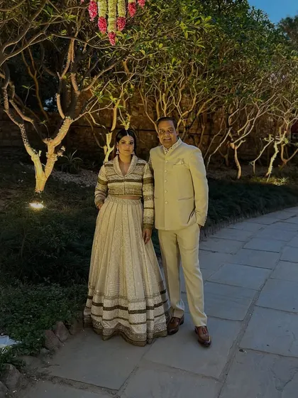 Another look with my father, this time in a coordinated cream-colored bandhgala and a striped Anarkali gown for a formal event.