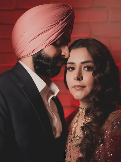 A romantic portrait of the couple. His classic double-breasted suit and her glittering floral lehenga create a look of pure glamour and sophistication.