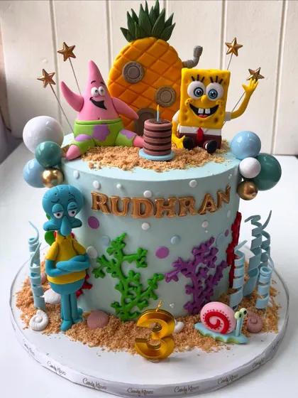 An underwater adventure with SpongeBob SquarePants and friends. This cake features hand-sculpted figurines of SpongeBob, Patrick, and Squidward, set in a vibrant Bikini Bottom scene with edible sand and coral.