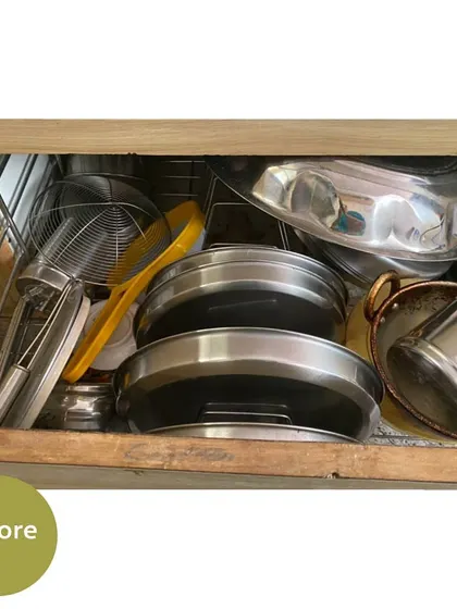 Before, this drawer was a messy pile of plates, lids, and strainers. This was part of a virtual kitchen organizing session.