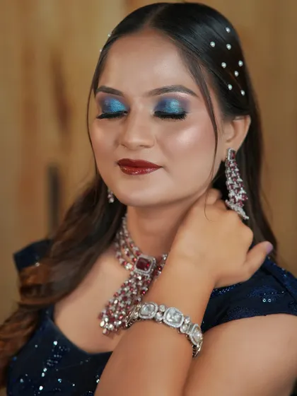 Another angle of the blue glitter eye look, showing the flawless blending and the beautiful ruby and diamond jewellery.