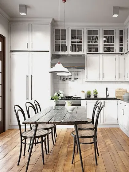 In this classic kitchen, a medium-toned wood floor brings warmth and texture, balancing the crisp white cabinetry. It's a timeless choice that proves wood flooring is perfectly at home in the kitchen.