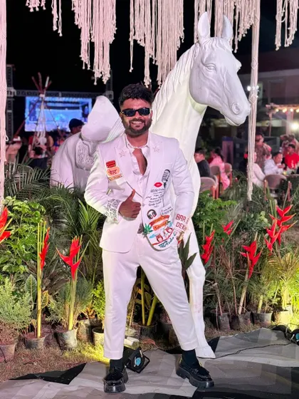 "I want people to see my dress but focus on the men wearing it." This custom white suit with quirky patches is a conversation starter.