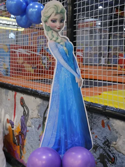 A life-sized cutout of Elsa from 'Frozen' adds a magical touch to the party decor, making birthday wishes come true.