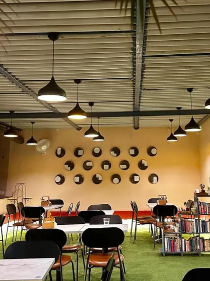 This wall at Café Quaint is a great example of upcycled art. We repurposed old dinner plates, painting and arranging them in a pattern that reflects the local architecture, turning something old into a meaningful and sustainable art installation.