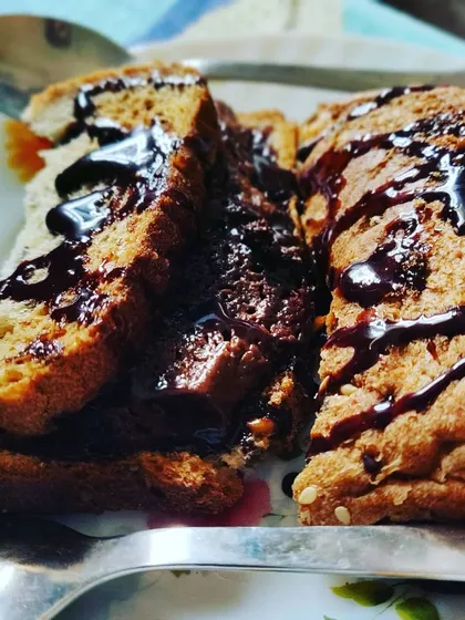 A perfect healthy dessert option: toasted bread drizzled with rich, dark chocolate sauce. Simple, yet incredibly satisfying.