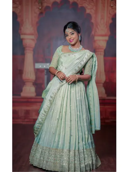 This hand-worked half-saree in a delicate mint green color is perfect for an elegant and subtle traditional look.