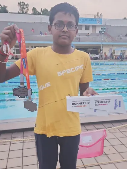 Advik showcasing his medals from the 2KM and 6KM events at the Kochi Swimathon.