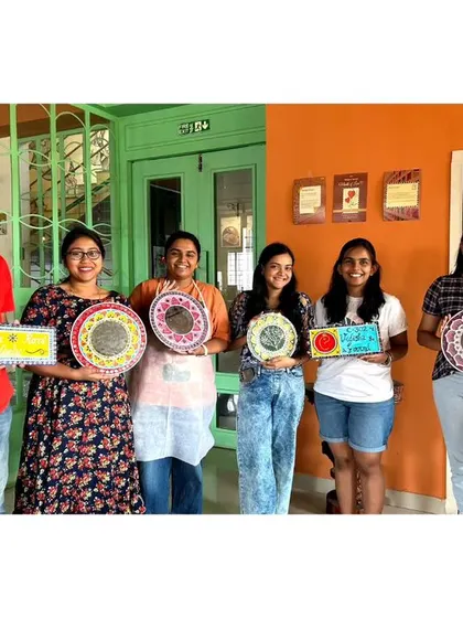 A group photo from a Lippan art workshop, with everyone holding their beautiful mirror and nameplate creations.