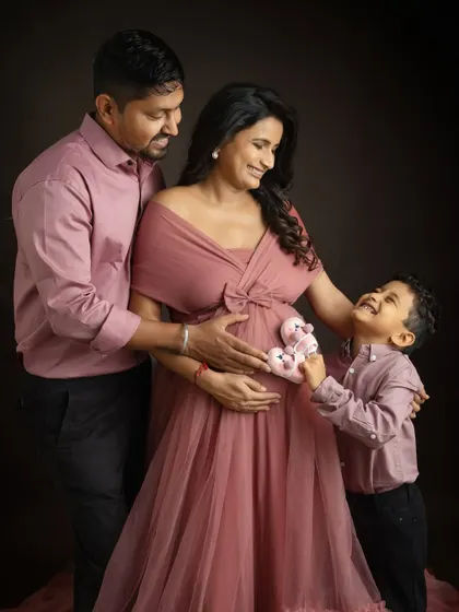 The big brother is ready for his new role. Having him hold the tiny baby shoes to the bump is such an adorable way to capture his excitement for the new arrival.