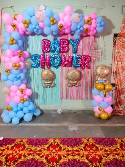 A clear, straight-on shot of the pink and blue baby shower backdrop. This simple and colorful setup is perfect for home-based celebrations.
