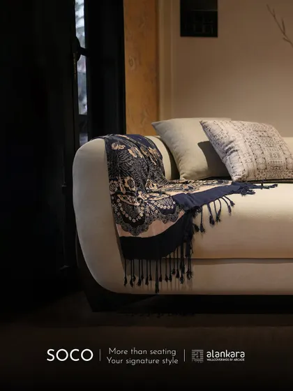 The Soco sofa styled with a decorative throw, illustrating how my pieces become a canvas for your personal style. More than just seating, it's a signature piece.