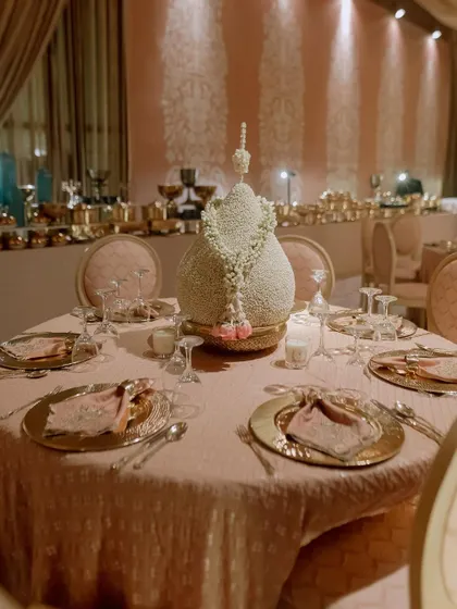 The dining tables were set with gold charger plates and elegant floral centerpieces made from mogra (jasmine). The design is traditional, fragrant, and incredibly beautiful.