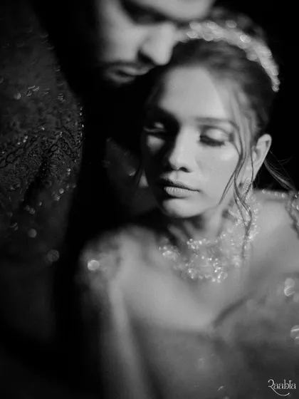 A soft, dreamy black and white portrait of Kairavi and Manan, capturing a quiet and intimate moment between the couple.