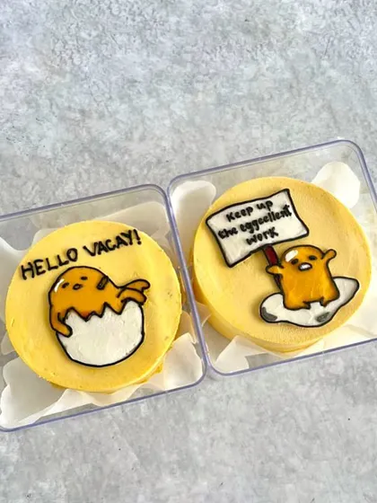 A pair of Gudetama (the lazy egg) themed mini bento cakes to celebrate the start of a school holiday.