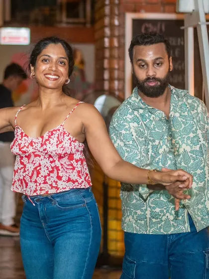 A stylish pair posing for the camera mid-dance. They bring so much personality to the floor.