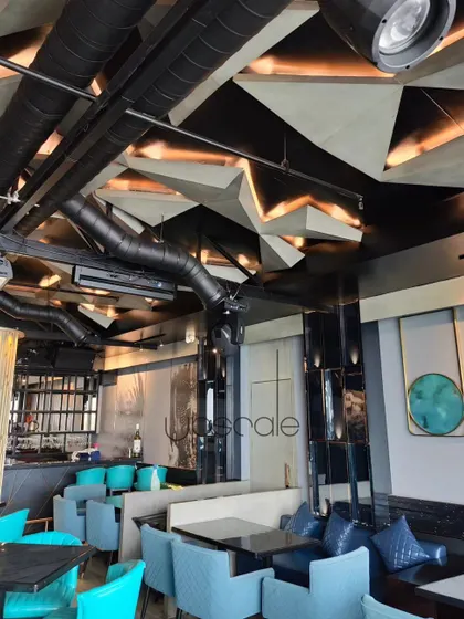 An overview of the NX Lounge, showcasing the interplay of the parametric ceiling, custom furniture, and curated art. Every element is designed to contribute to a cohesive and immersive experience, balancing bold design with comfortable seating arrangements.