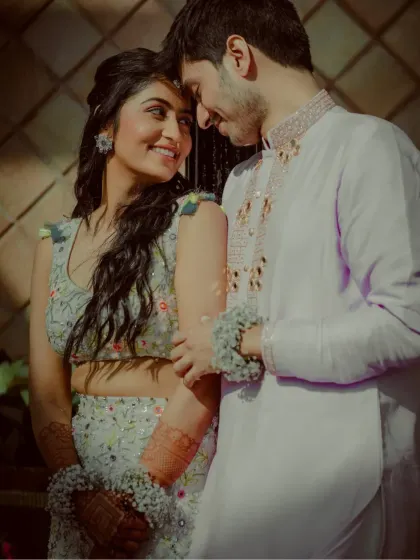 A close-up, intimate portrait of the couple, filled with soft smiles and loving gazes.