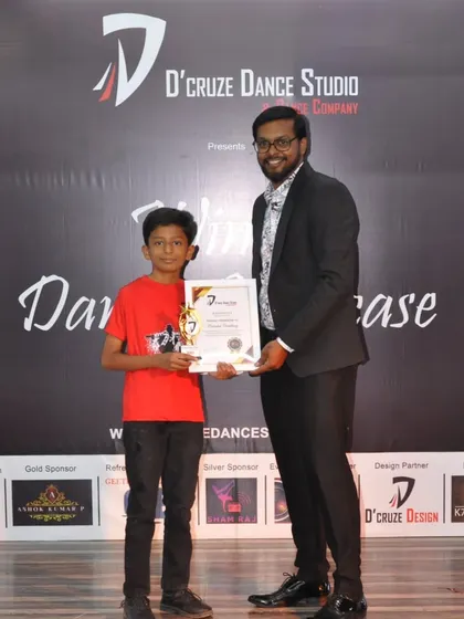 A proud student receiving his certificate and award at our showcase event.