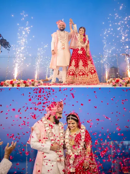 A grand celebration with fireworks and a shower of rose petals as the couple stands on stage after their wedding ceremony.