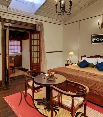 A well-appointed guest room with a dedicated seating area, showcasing a comfortable and functional layout for travelers.