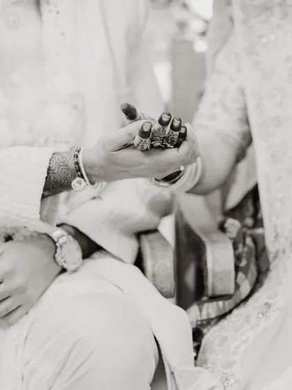 A close-up of a ritual, focusing on the hands and the symbolic objects used, telling a story of tradition.