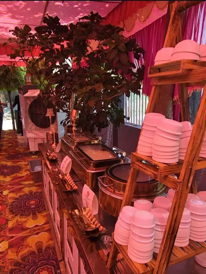 A rustic-themed buffet setup featuring a wooden ladder shelf for bowls and plates. This style is perfect for adding a warm and charming touch to daytime events or themed parties.