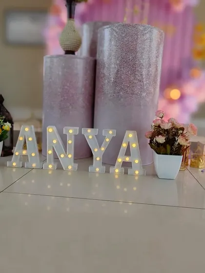 A close-up of the personalized details, including the light-up marquee letters spelling 'Anya'.