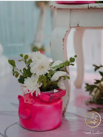 A close-up of a quirky pink kettle used as a flower vase, a great example of my creative decor details.