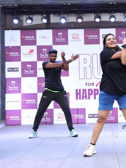 Demonstrating warm-up stretches on stage. Proper form is key to preventing injuries, and I make sure to guide the runners through each move safely.