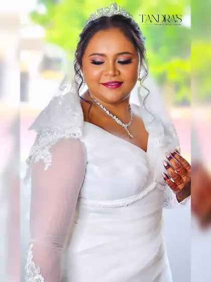 A beautiful Christian bride, Monica, whose traditional white gown is perfectly complemented by her intricate mehendi.