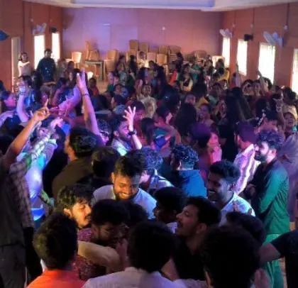 The dance floor is a sea of motion at this college event.