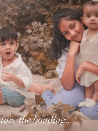 "Capture the bonding." A candid moment from an outdoor sibling shoot, showing the fun and sometimes chaotic reality of life with little ones.
