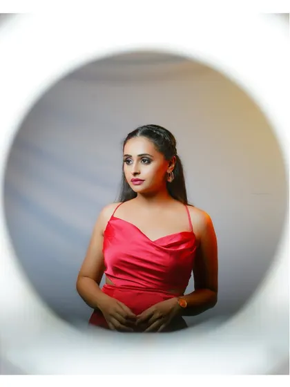 A creative portrait using a circular frame effect. This adds an artistic and unique touch to a standard studio shot.