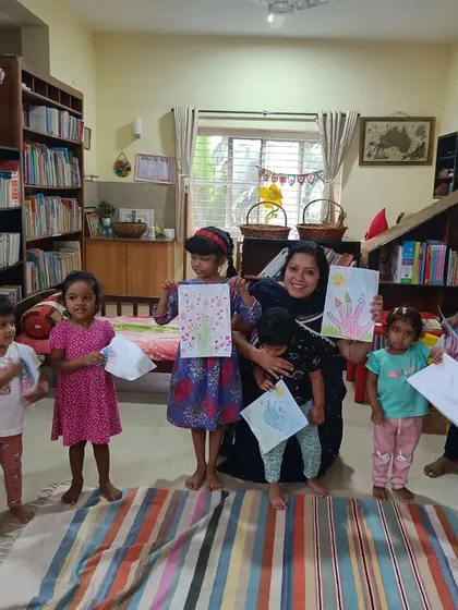 A duplicate shot capturing the happy smiles of the children with their artwork.