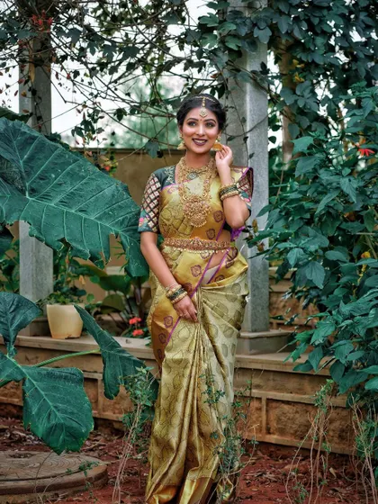 A full-length view of the editorial look, showing how the makeup complements the unique saree and lush green background.