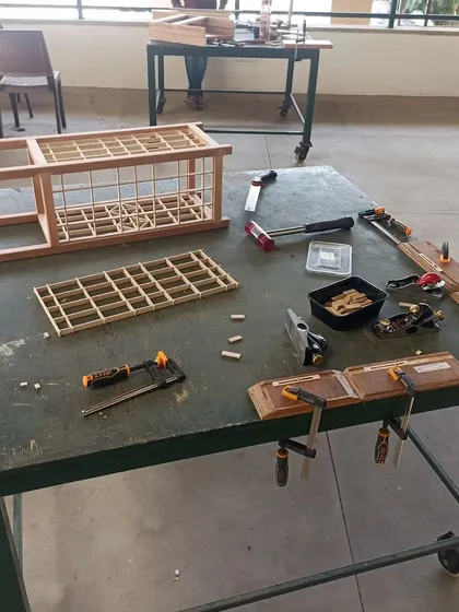 The process of building a Kumiko lamp, with the frame and panels laid out. This project was made by students from grades 6 to 8, proving that with patience, anyone can learn this craft.