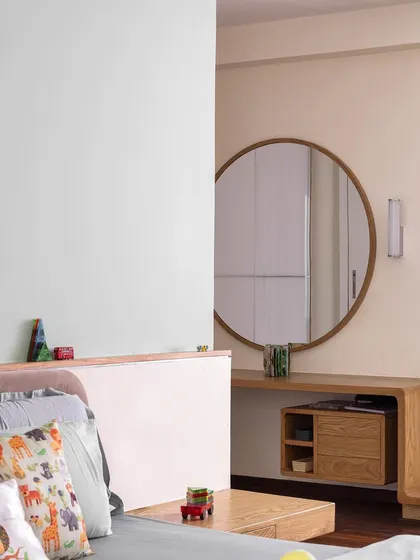 The kids' bedroom in 'A Walk in the Clouds' features a platform bed and a custom curved dresser and study table, all in a soft, pastel green palette.