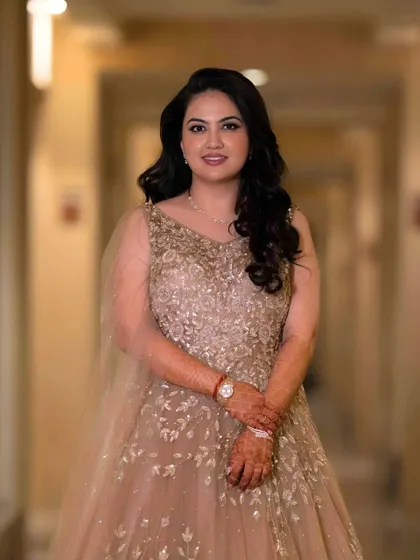 A full-length shot of the bride-to-be. Her makeup is minimal and radiant, perfectly complementing her embellished gown.