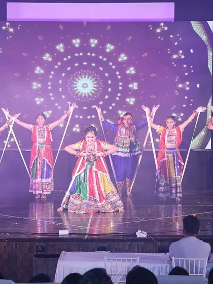 A vibrant Garba performance on the big stage. Our students showcase the beauty of Indian folk dance with dandiya sticks and colorful traditional attire.