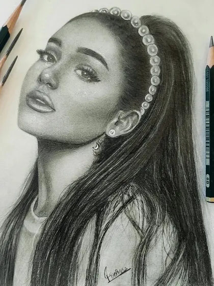 A realistic graphite portrait of Ariana Grande. I focused on capturing her distinct features and the soft texture of her hair, using professional Faber-Castell pencils for a smooth, lifelike finish.