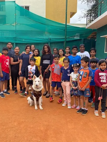 A great group photo with my students and our furry friend. Coaching is a challenging but incredibly fun part of my life, and I love the energy my players bring to the court every day.