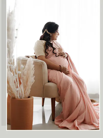 A side profile portrait that captures the elegance of the mom-to-be. The simple, pulled-back hairstyle and soft makeup ensure the focus remains on her and the beautiful moment.