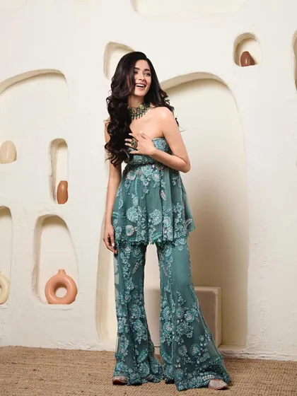 This embroidered peplum and flared trouser set on Geethika is a fantastic alternative to a traditional lehenga for a wedding event. It's chic, comfortable, and incredibly stylish.