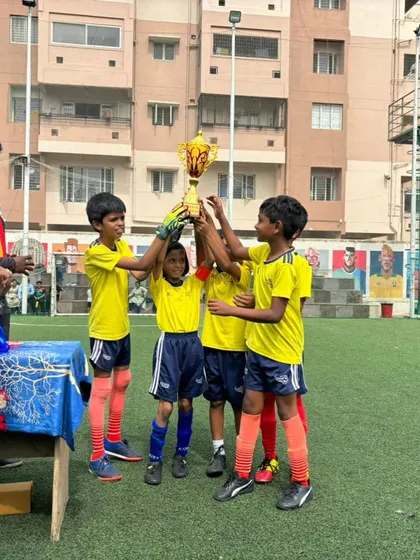 Our Under-10 team lifting the runner-up trophy at the BEL Cup. They played with heart and showed great potential.
