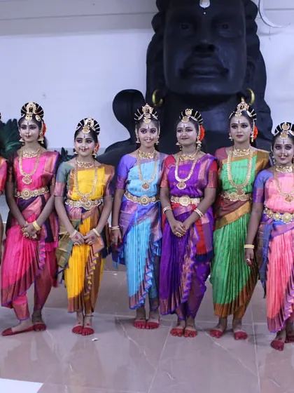 My talented troupe of dancers in their beautiful costumes for the 'Nava Durga' production, posing in front of a magnificent Shiva statue.