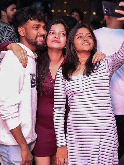 Friends taking a selfie to capture the memory of a fun night out.