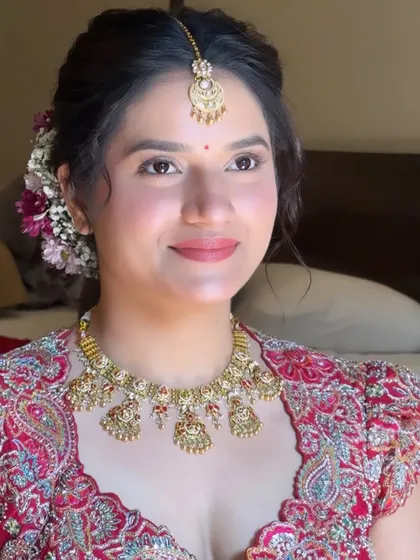 A beautiful portrait of Yogita on her wedding day. I created a soft, natural look with a hint of color on the lips and cheeks to complement her red saree, perfect for her outdoor ceremony.