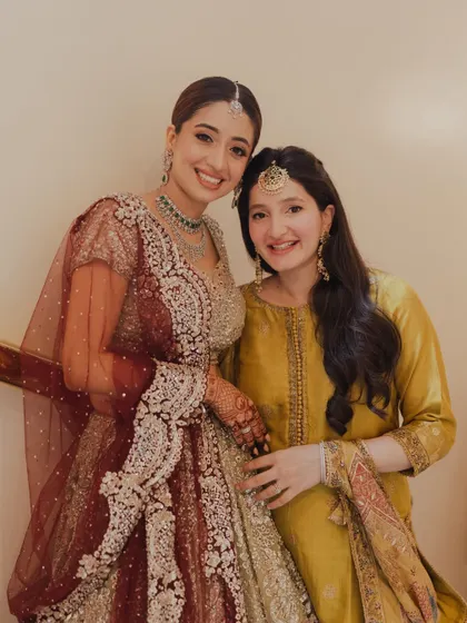 A heartwarming photo of the bride with her sister. Both are glowing, showcasing how I create complementary looks for the entire bridal family.