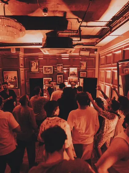 The view from the back of the room. A packed house enjoying the music under the red lights.